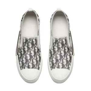 Dior B23 Slip On Sneaker: White and black slip-on sneakers with a white rubber sole for men. Price: $350.
