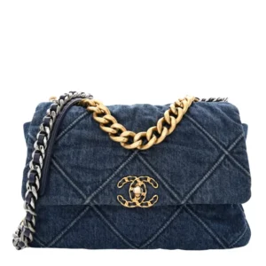 A blue quilted Chanel 19 Denim bag with a gold chain strap and a prominent gold emblem in the center for women's.
