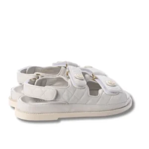 Chanel White Velcro Dad sandals with a buckle and two straps, perfect for a stylish summer look.