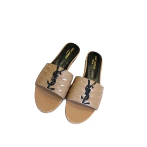 A pair of nude YSL Flat sandals with black Monogram, perfect for a stylish and versatile look.