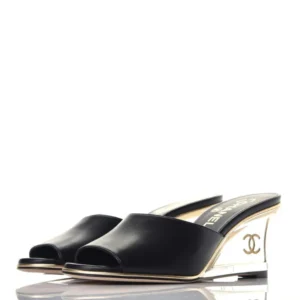 Stylish black wedge Mules sandals by Chanel, perfect for a chic summer look.