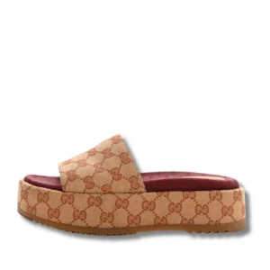 Make a fashion statement with these Gucci GG Canvas Platform Slides adorned with a stunning multicolored print.
