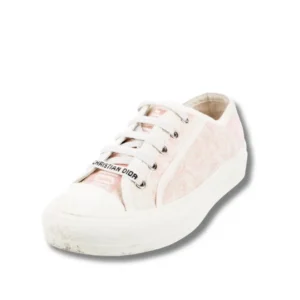 A Dior Walk'n'Dior Pink sneakers with white laces and sole, a trendy footwear that combines comfort and style effortlessly.