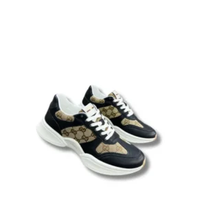 Gucci GG Canvas Sneakers showcasing a sleek brown and black monogram pattern, a must-have for any sneaker enthusiast.