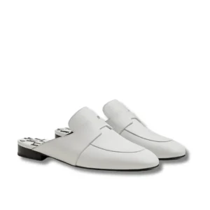 White Hermes Catena mules with a sleek black heel, perfect for adding a touch of elegance to any outfit.