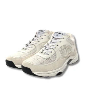 Classic Chanel Logo Runner sneakers in white with laces, a timeless addition to any wardrobe.