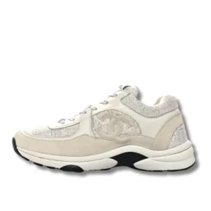 Classic Chanel Logo Runner sneakers in white with laces, a timeless addition to any wardrobe.